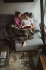 Couple lecture de livres dans le salon à la maison — Photo de stock