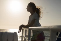 Thoughtful woman standing on cruise ship — Stock Photo