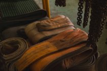 Rubber belts and rustic chain in storage compartment of workshop — Stock Photo