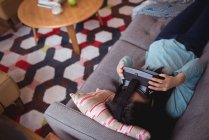 Mulher usando fones de ouvido de realidade virtual na sala de estar em casa — Fotografia de Stock
