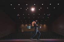 Male singer performing on stage at theatre. — Stock Photo