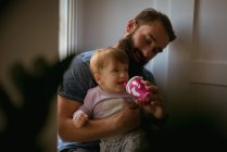 Father feeding his son at home — Stock Photo