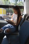 Teenage girl reading a book in the bus — Stock Photo