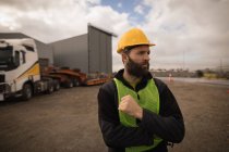 Thoughtful dock worker standing in shipyard — Stock Photo