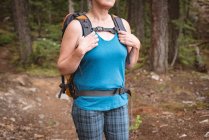 Mid section of mature woman standing in the forest — Stock Photo