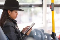 Дівчина-підліток використовує цифровий планшет в автобусі — стокове фото