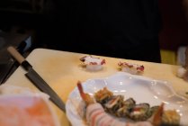 Mesa de sushi arreglada en un restaurante en un día soleado - foto de stock