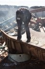 Rear view of worker cutting the metal in the scrapyard — Stock Photo