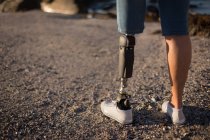 Baixa seção de mulher com deficiência em pé na praia . — Fotografia de Stock