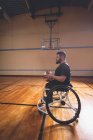 Side view of disabled man practicing basketball in the court — Stock Photo