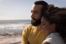 Smiling couple standing near beach on a sunny a day — Stock Photo