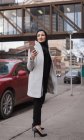 Mulher no hijab usando telefone celular na rua da cidade — Fotografia de Stock