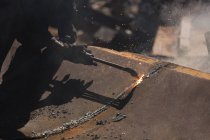 Close-up of worker cutting the metal in the scrapyard — Stock Photo