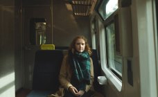 Portrait of woman travelling in train — Stock Photo
