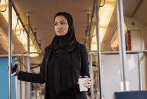 Young woman in hijab travelling in train — Stock Photo