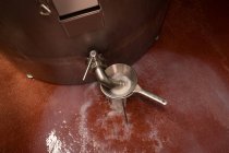 Flüssigkeit wird gefiltert und quillt aus dem Tank in der Lebensmittelfabrik — Stockfoto