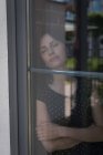 Женщина исполнительный расслабляющий около окна в офисе — стоковое фото