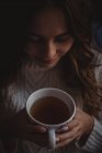 Nahaufnahme einer schönen Frau, die das Aroma des Tees riecht — Stockfoto