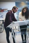 Executives working on drafting table in modern office — Stock Photo