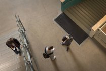 High angle view of college students using mobile phone — Stock Photo