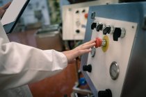 Worker pressing the control switch in food factory — Stock Photo