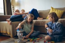 Fratelli che giocano con i giocattoli in soggiorno a casa — Foto stock