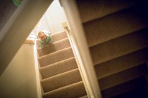 Baby girl crawling on steps at home — Stock Photo