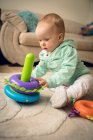 Adorable baby girl playing with toys at home — Stock Photo