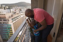 Father and son playing in balcony at home. — Stock Photo