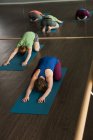 Groupe d'athlètes de fitness pratiquant le yoga dans un studio de fitness . — Photo de stock