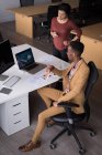 Office colleagues discussing on laptop at desk in the office — Stock Photo