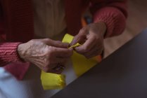 Senior woman doing craft work at nursing home — Stock Photo