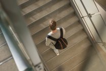 Overhead of college student walking on staircase — Stock Photo