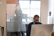 Мужчина-руководитель, работающий за компьютером в офисе — стоковое фото