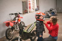 Mutter bereitet ihren Sohn in Garage auf Fahrradfahren vor — Stockfoto