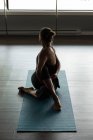 Женщина практикует упражнения на растяжку в фитнес-студии . — стоковое фото