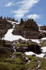 Frozen glacier on rock mountain during sunny day — Stock Photo