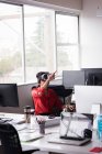Female office executive experiencing virtual reality headset on desk at creative office — Stock Photo