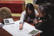 Couple discussing over blueprint at home — Stock Photo