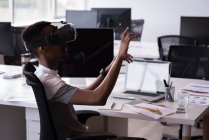 Office executive using Virtual reality headset on his desk in the office — Stock Photo