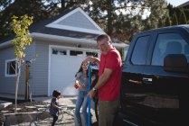 Padre e figlia si divertono mentre lavano l'auto fuori dal garage — Foto stock