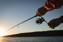 Close-up of male hands fishing in river. — Stock Photo
