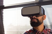 Executivo masculino usando fone de ouvido de realidade virtual no escritório — Fotografia de Stock