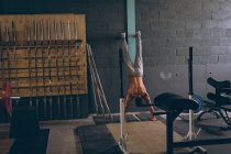 Решительный мускулистый человек тренируется в фитнес-студии — стоковое фото