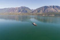 Bootsfahrt im türkisfarbenen Meer und den Bergen im Hintergrund — Stockfoto