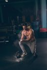 Мускулистый мужчина растирает порошок в руках в фитнес-студии — стоковое фото