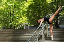 Female ballet dancer dancing on the steps — Stock Photo