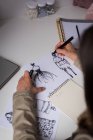High angle view of fashion designer making sketches in design studio. — Stock Photo