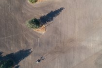 Aerial of tractor plowing the field on a sunny day — Stock Photo