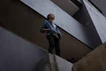 Продуманий молодий чоловік стоїть на балконі — стокове фото